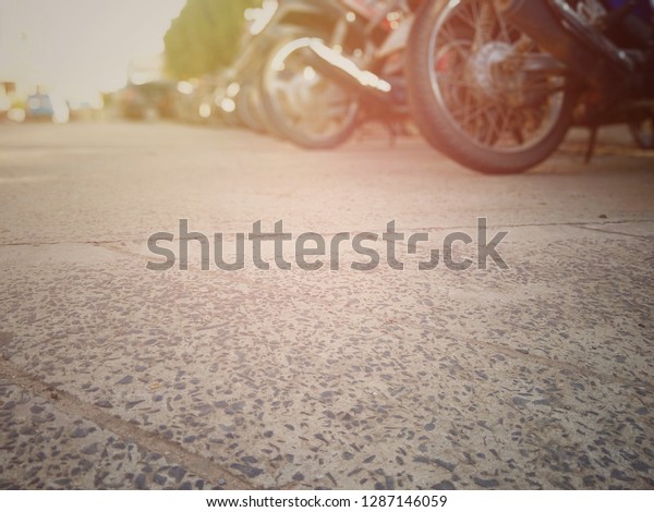 Motorbikes\
parked in the parking area, blurred\
pictures