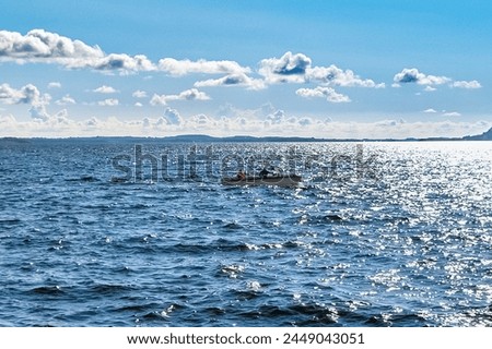 Motorboat against the backdrop of the azure Northern Sea and sky. Norway. Summer