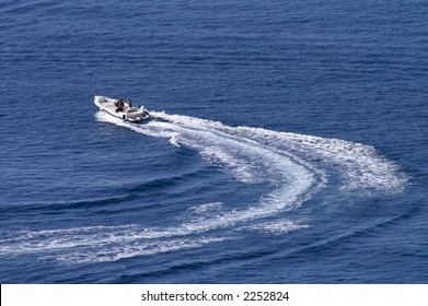 Motorboat Changing Course  At Full Power Leaving Curved Wake Behind