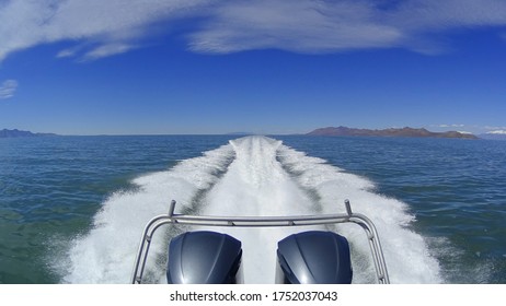 Motorboat with dual outboard engines powers across the Great Salt Lake in Utah