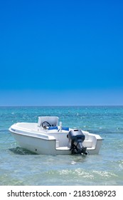 motorboat on the beach under a blue sky