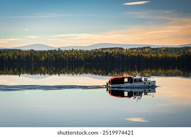 Motorboat on a calm lake, surrounded by an autumn forest and distant mountains under a clear sky. The water reflection and warm light create a serene and natural atmosphere. - Powered by Shutterstock