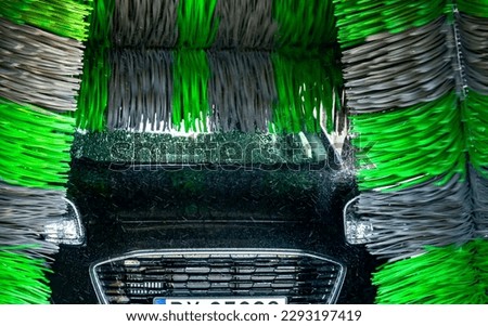 A motorcar in an automatic car wash.