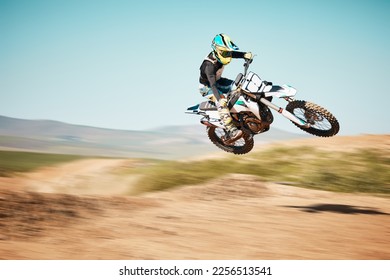 Motorcross, air jump and offroad sports with motion blur, speed challenge or desert. Driver, cycling and stunt on dirt track, competition and motorbike performance on adventure course for fast action