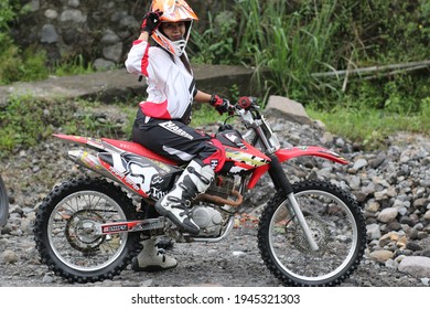 Motorcross Driver Woman Road In Forest. Dirt Motocross Bike Rider Woman. Osaka Japan. March 28, 2021