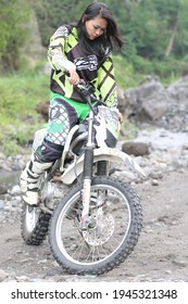 Motorcross Driver Woman Road In Forest. Dirt Motocross Bike Rider Woman. Osaka Japan. March 28, 2021