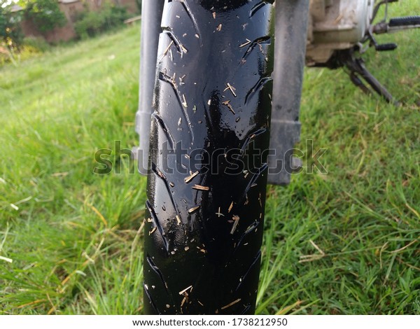 Motorcycle black\
rubber tires get wet after\
driving