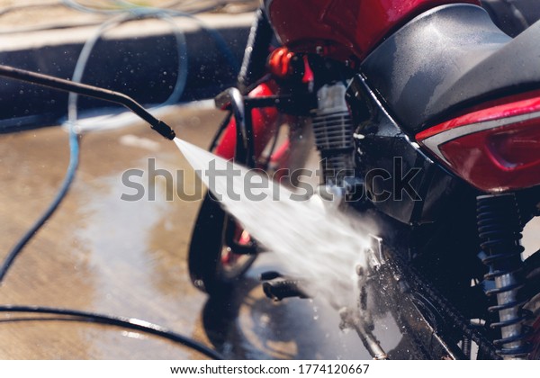 Motorcycle Car\
Wash Motorcycle Big Bike cleaning with foam injection Make more\
clean. Bike rider washing his\
motorcycle