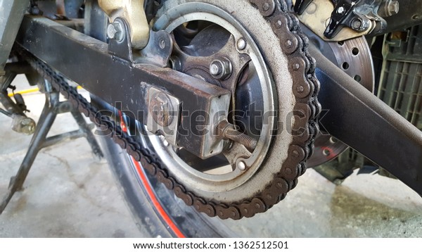 Motorcycle chain is corrosion. Lack of care\
causes the chain motor become damaged and corrosion so that law\
becomes obstructed