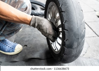 The Motorcycle Change Tire By Man Repairer At Bangkok Thailand.