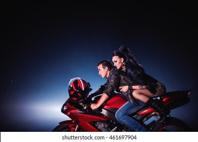 Motorcycle. Couple Sitting On A Red Motorcycle. Sport Bike. Man Drives A Motorcycle At Night. Couple And A Motorcycle.