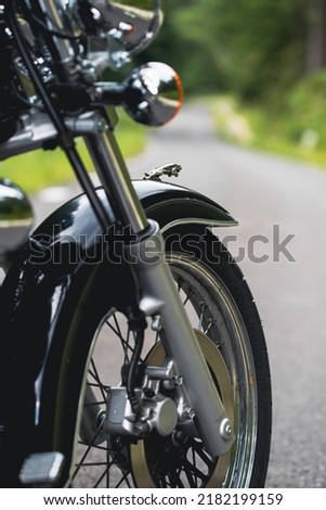 Similar – Image, Stock Photo Black motorcycle on road over nature background