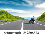 motorcycle drive on the europe coastal road landscape in summer. Riding a motorcycle is freedom. motorbike driver is speeding along the travel road. Sea view on highway on the Mediterranean beach