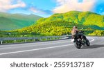 motorcycle drive on the europe nature road landscape in summer. Riding a motorcycle is freedom. motorbike driver is speeding along the travel road. Mountain view on highway on europe green mountains.