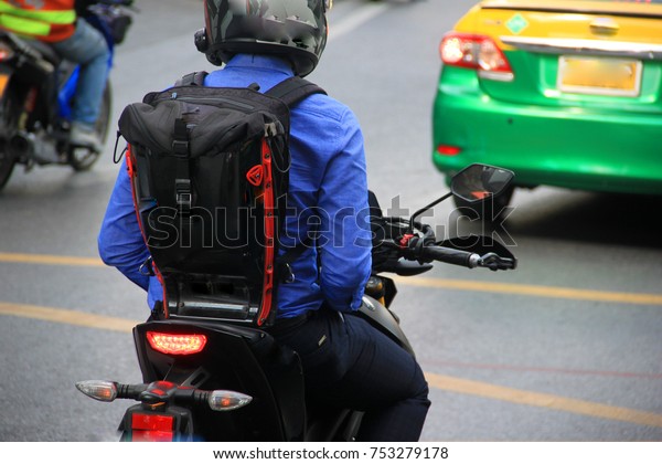 Motorcycle driver parked in\
red light.