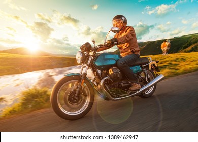 Motorcycle driver riding in Alpine highway, Nockalmstrasse, Austria, central Europe.