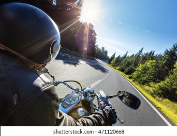 Motorcycle Driver Riding On Motorway In Beautiful Sunset Light. Shot From Pillion Driver View