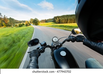 Motorcycle Driver Riding On Motorway In Beautiful Sunset Light. Shot From Pillion Driver View