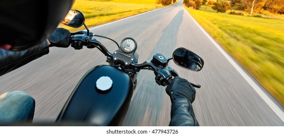 Motorcycle Driver Riding On Motorway In Beautiful Sunset Light. Shot From Pillion Driver View