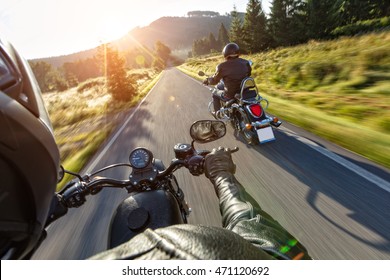 Motorcycle Drivers Riding On Motorway In Beautiful Sunset Light. Shot From Pillion Driver View