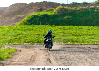 Motorcycle driving on a country road in the countryside at sunset. - Powered by Shutterstock