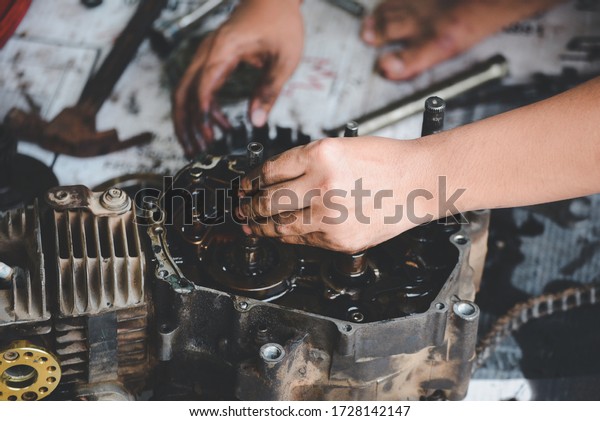 Motorcycle engines working repaired by mechanic\
in garage Repair\
service.