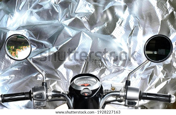 Motorcycle\
front view on reflective silver\
background