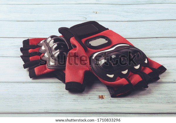 Motorcycle gloves\
isolated on wooden\
table