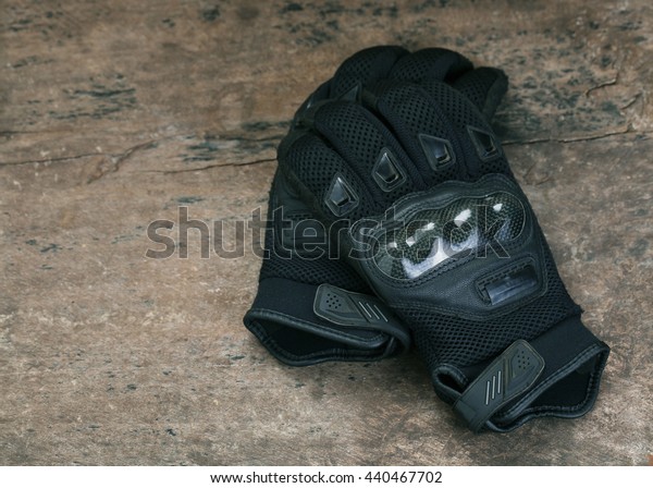 Motorcycle\
gloves on wooden background,with copy\
space.