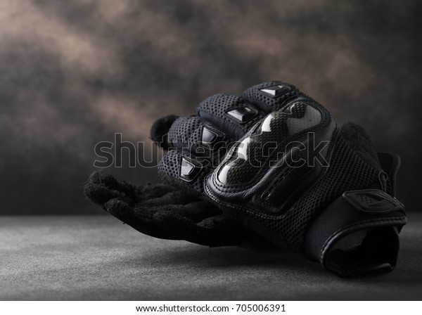 Motorcycle gloves on wooden background,with copy\
space -vintage\
effect.