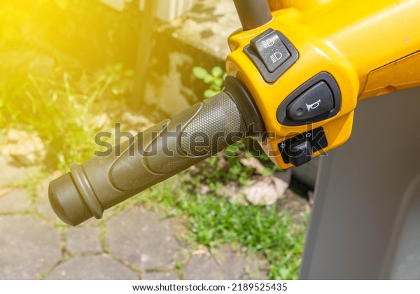 motorcycle handlebar horn\
yellow closeup.