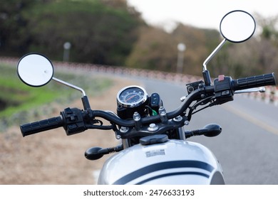 Motorcycle handlebars, mirrors and speedometer view. Road view from vintage motorcycle. Bike theme background. - Powered by Shutterstock