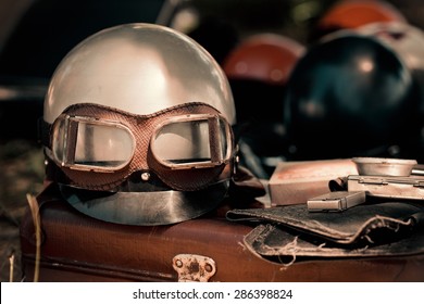 Motorcycle Helmet With Goggles And Other Retro Objects. Vintage Driver Equipment - Romantic Travel On Motorbike.