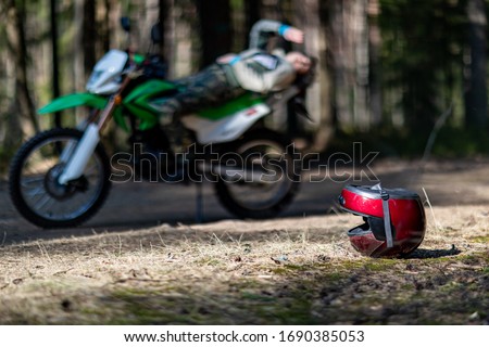 motorcycle helmet lies on the ground, biker, equipment for a motorcyclist, beautiful poses, attracts, motorcycle driver, concept, active lifestyle, enduro