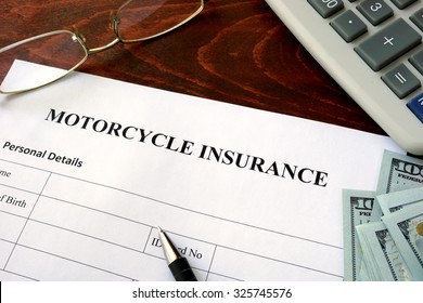 Motorcycle Insurance  Form And Dollars On The Table.