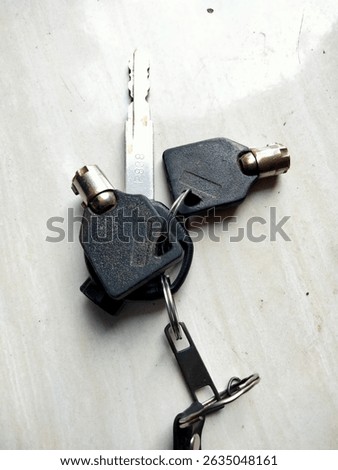 a motorcycle key and a double key