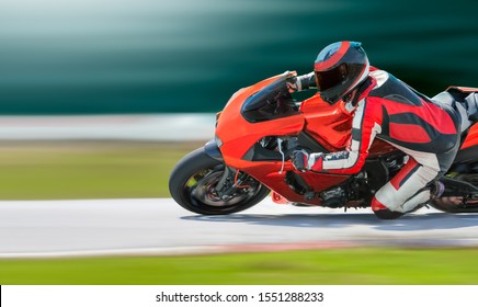 Motorcycle Leaning Into A Fast Corner On Race Track