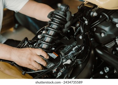 motorcycle mechanic check and Change rear Shock Absorbers motorcycle at motorcycle garage,   repair, maintenance and service concept      - Powered by Shutterstock