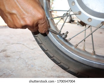 motorcycle mechanic working with wrench in garage. Repair service. - Shutterstock ID 1700547004