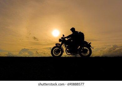 Motorcycle Or Motorbike Silhouette With Traveler Male Rider Standing At The River.
