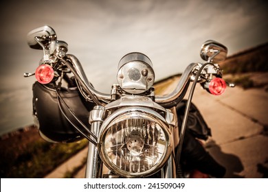 Motorcycle On The Road With A Helmet On The Handlebars.