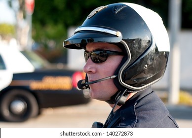 A motorcycle police officer watches traffic during his shift. - Powered by Shutterstock