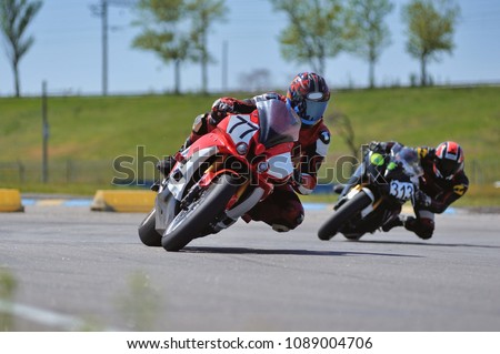 Motorcycle practice leaning into a fast corner on track