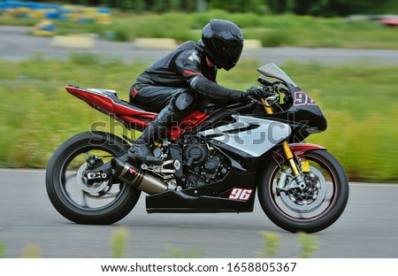 Motorcycle practice leaning into a fast corner on track