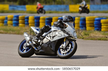 Motorcycle practice leaning into a fast corner on track
