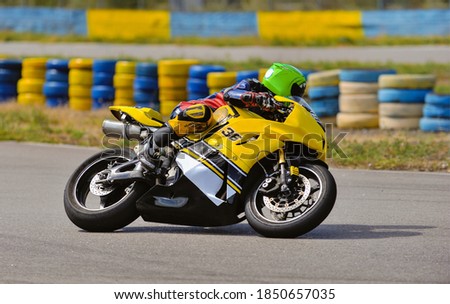 Motorcycle practice leaning into a fast corner on track