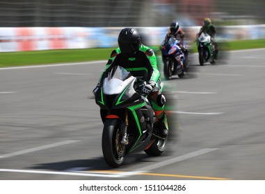 Motorcycle racers compete at high speed on the race track