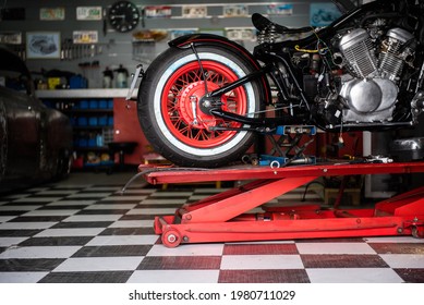 motorcycle raised on the platform to be repaired in a mechanic's shop. mechanics concept. vintage motorcycle
