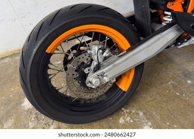 Motorcycle rear wheel with decorative orange paint. Close-up. - Powered by Shutterstock