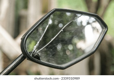 Motorcycle rearview mirror cracked with reflection